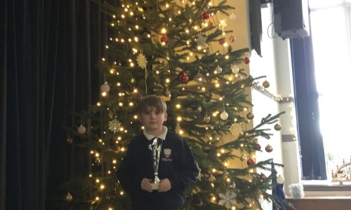 Child holding chess trophy.